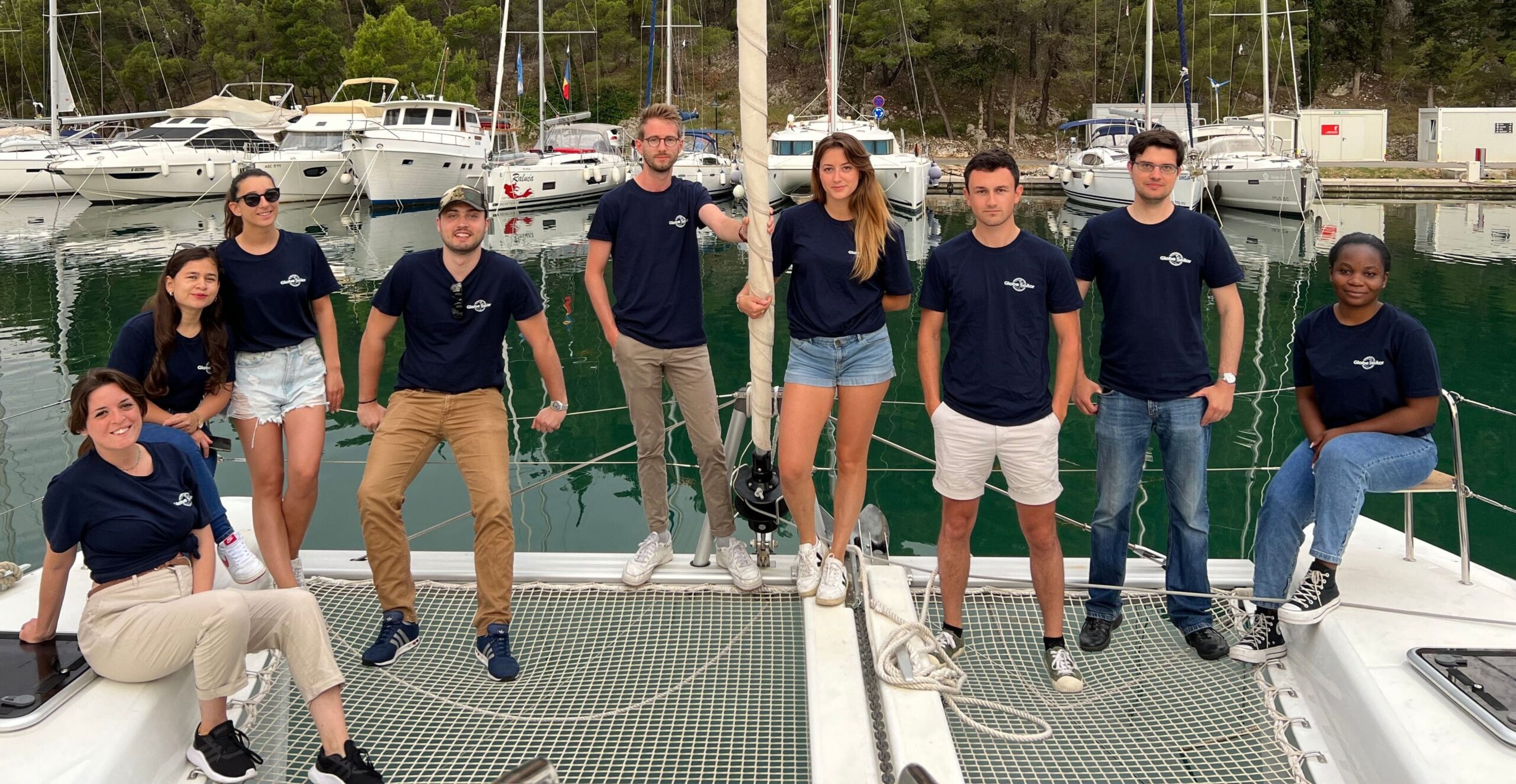 Team in front of a boat